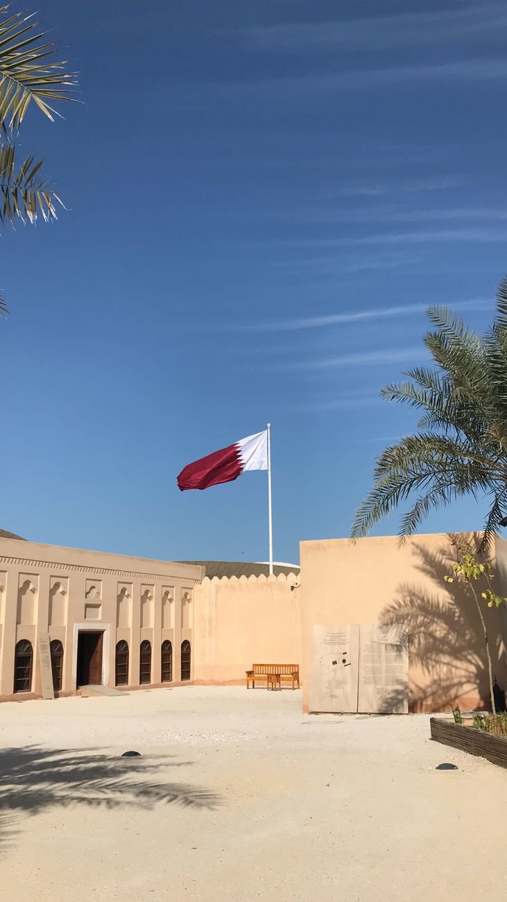 Traditional Qatari Courtyard with National Flag